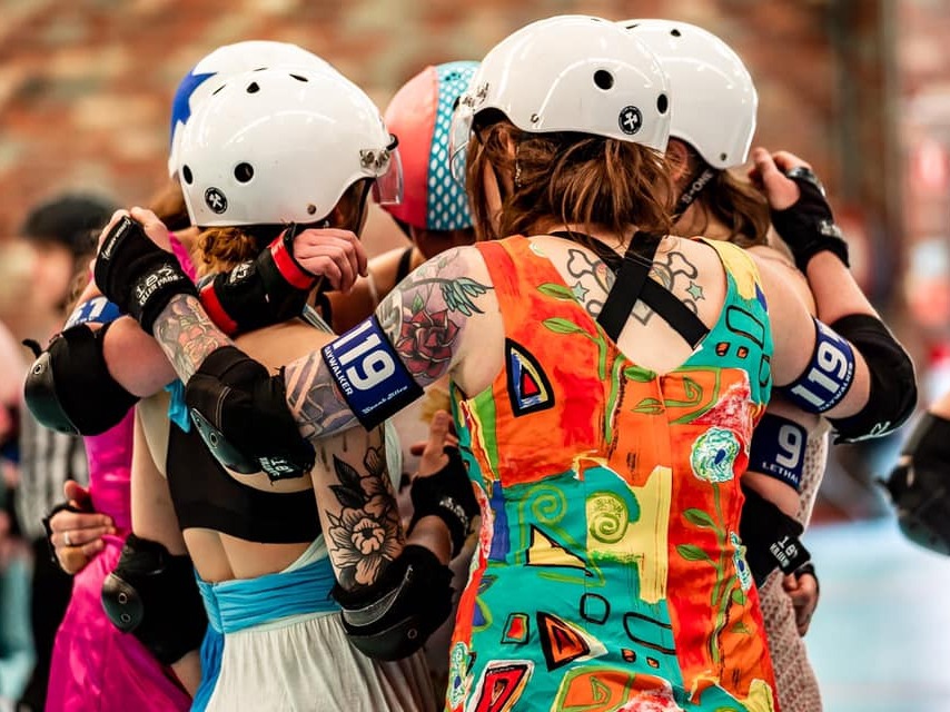 Victorian Roller Derby League Skaters huddled together talking strategy at one of our fun dress-up games.