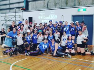 An end of game photo of Victorian Roller Derby League with the opposing team. Everyone tired and happy after a great game.